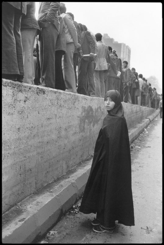 عباس عطار. زنی در تظاهرات ضد شاه پشت مردان ایستاده، تهران، 1978