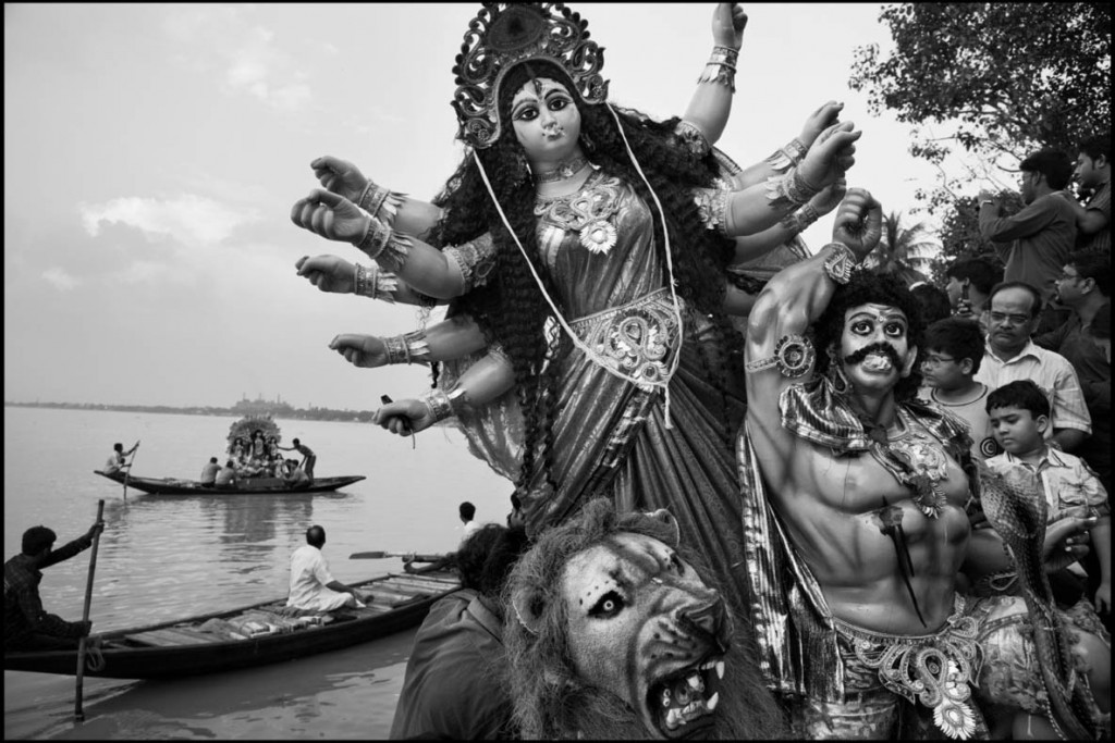 عباس عطار. پیش‌مرگ‌های هندو پس از مراسم دعا، تندیس دورگا (تجسم خدای کالی در بنگال) را به آب رودخانه هوگلی می‌سپارند، کلکته، بنگال غربی، هند